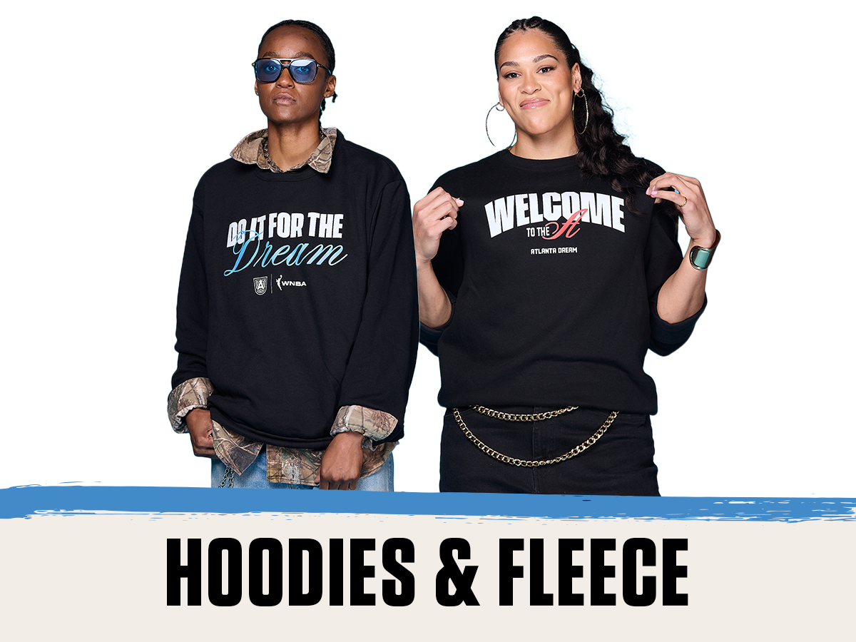 Two players showcase black Atlanta Dream fleece tops. On the left, a SWK wears a “Do It For The Dream” sweatshirt layered over a camo shirt and accessorized with blue sunglasses. On the right, Brionna Jones, wears a “Welcome to the A” crewneck with gold hoop earrings, a chain belt, and a green Apple Watch. The graphic below reads “HOODIES & FLEECE.”