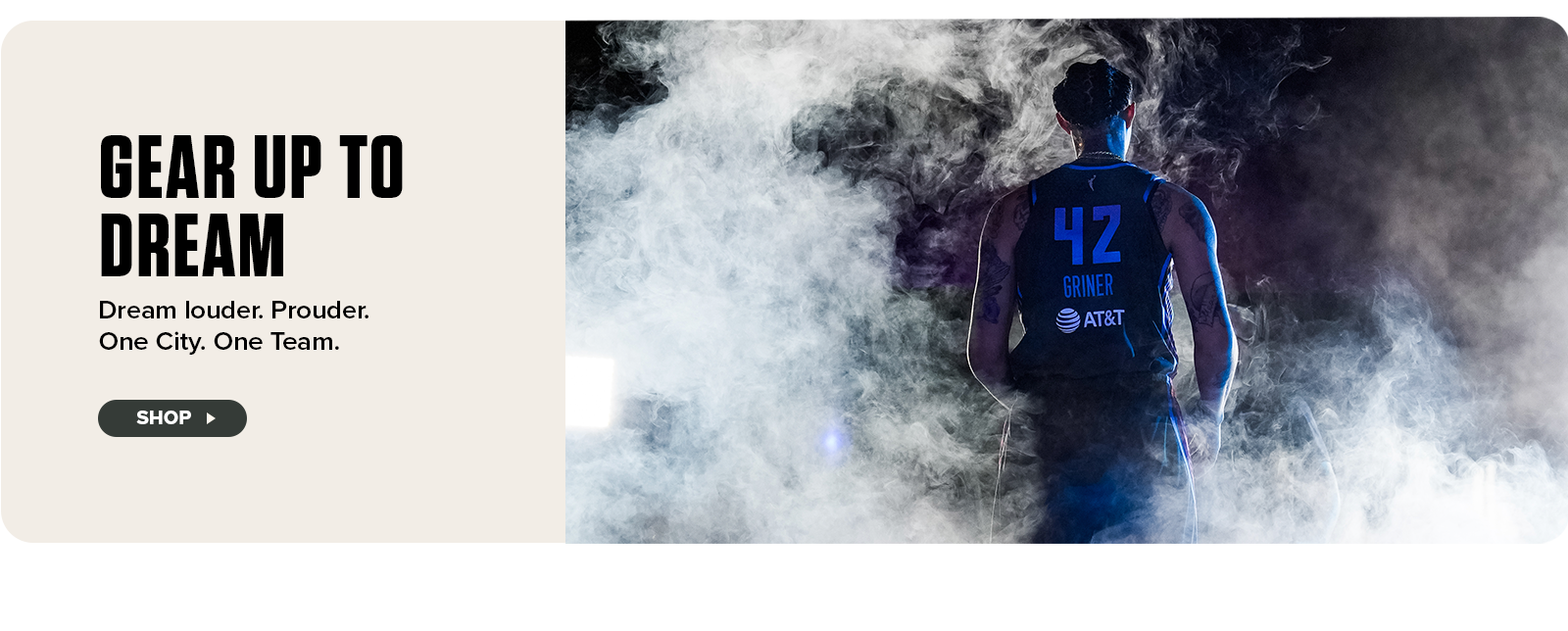 A powerful image of WNBA player Brittney Griner, seen from behind wearing a dark Atlanta Dream jersey with the number 42, stands in a cloud of dramatic smoke and spotlight. Below, bold text reads “Gear Up to Dream” with the tagline “Dream Louder. Prouder. One City. One Dream.” A “Shop” button invites fans to explore the collection.







