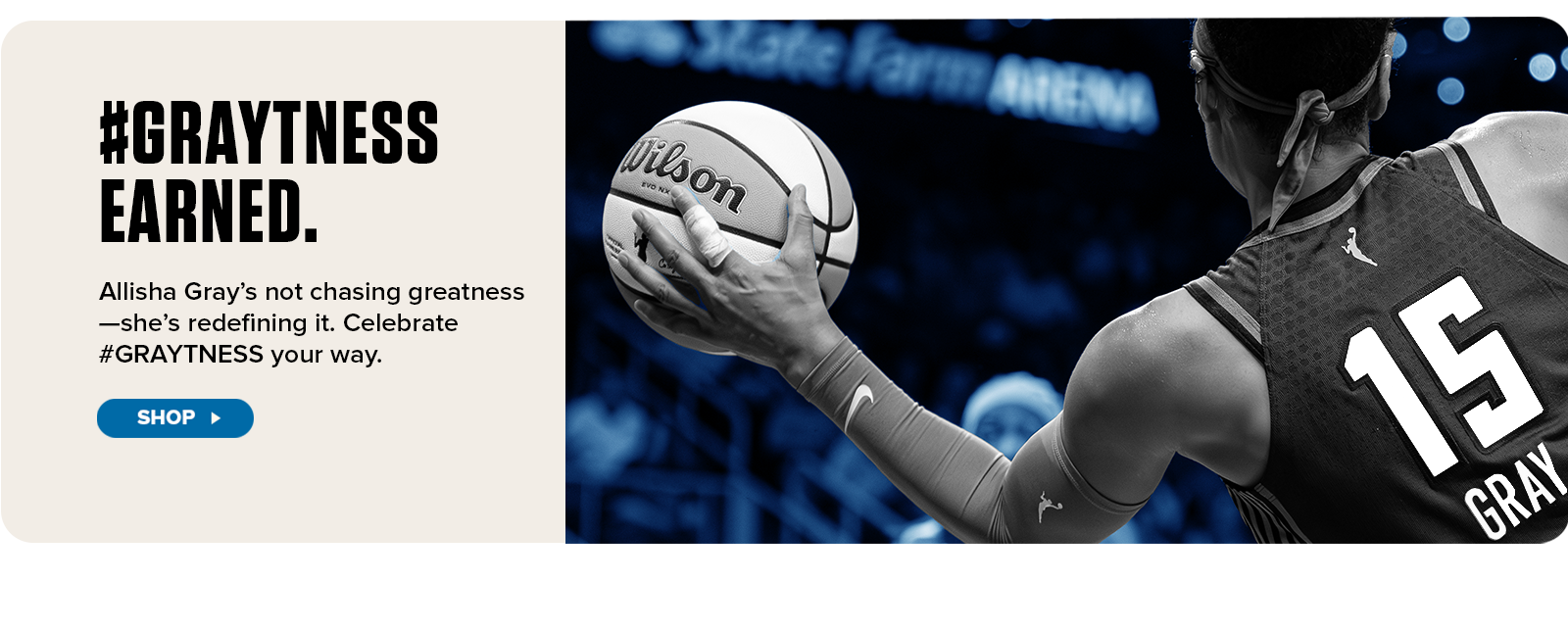 Promotional banner featuring WNBA player Allisha Gray in an action shot from behind, wearing jersey number 15 and holding a Wilson basketball. The text reads “#GRAYTNESS EARNED. Allisha Gray’s not chasing greatness—she’s redefining it. Celebrate #GRAYTNESS your way.” A blue “Shop” button appears below, inviting fans to purchase Atlanta Dream gear.