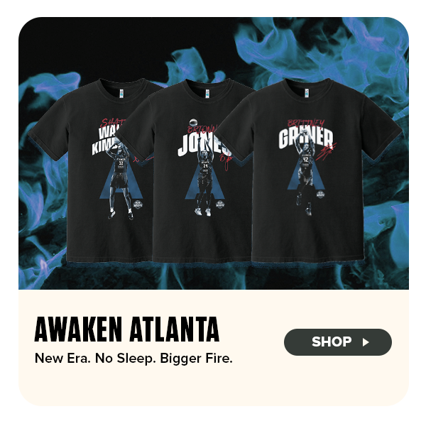 Three black Atlanta Dream player t-shirts featuring Brionna Jones, Brittney Griner, and Shatori Walker-Kimbrough are displayed in front of a dramatic blue flame background. Each tee showcases dynamic player imagery with bold text and signature details. On the left, the graphic reads “Awaken Atlanta” with the tagline “New Era. No Sleep. Bigger Fire.” A “Shop” button encourages fans to explore the collection.