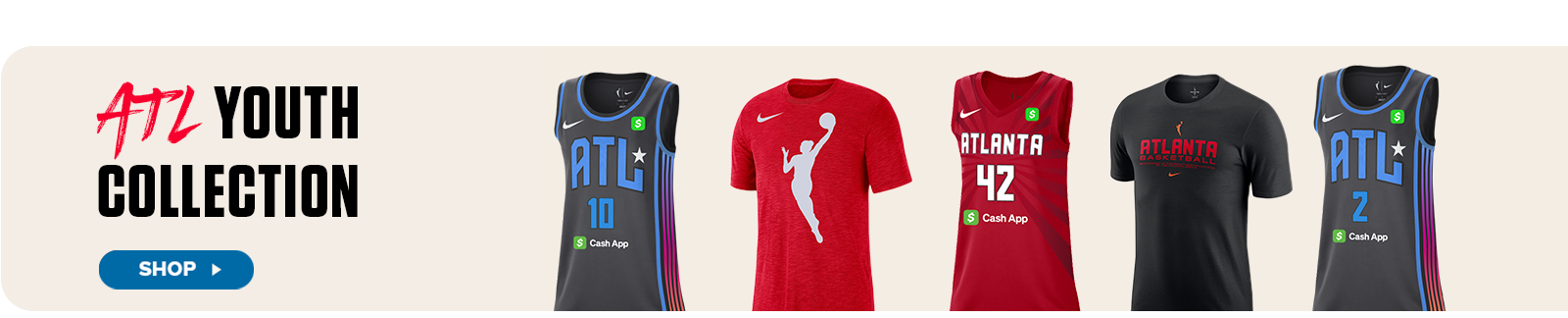 A lineup of five youth-sized Atlanta Dream apparel items is displayed under the headline “ATL Youth Collection.” The products include black and red basketball jerseys featuring player numbers, a red WNBA logo t-shirt, a red Atlanta Dream jersey with the number 42, and a black tee with “Atlanta Basketball” printed across the chest. Each piece includes the Nike and Cash App logos. A “Shop” button on the left invites viewers to explore the collection.