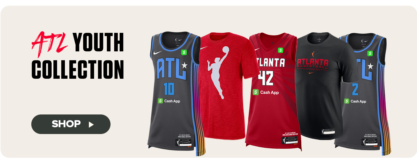 A lineup of five youth-sized Atlanta Dream apparel items is displayed under the headline “ATL Youth Collection.” The products include black and red basketball jerseys featuring player numbers, a red WNBA logo t-shirt, a red Atlanta Dream jersey with the number 42, and a black tee with “Atlanta Basketball” printed across the chest. Each piece includes the Nike and Cash App logos. A “Shop” button on the left invites viewers to explore the collection.