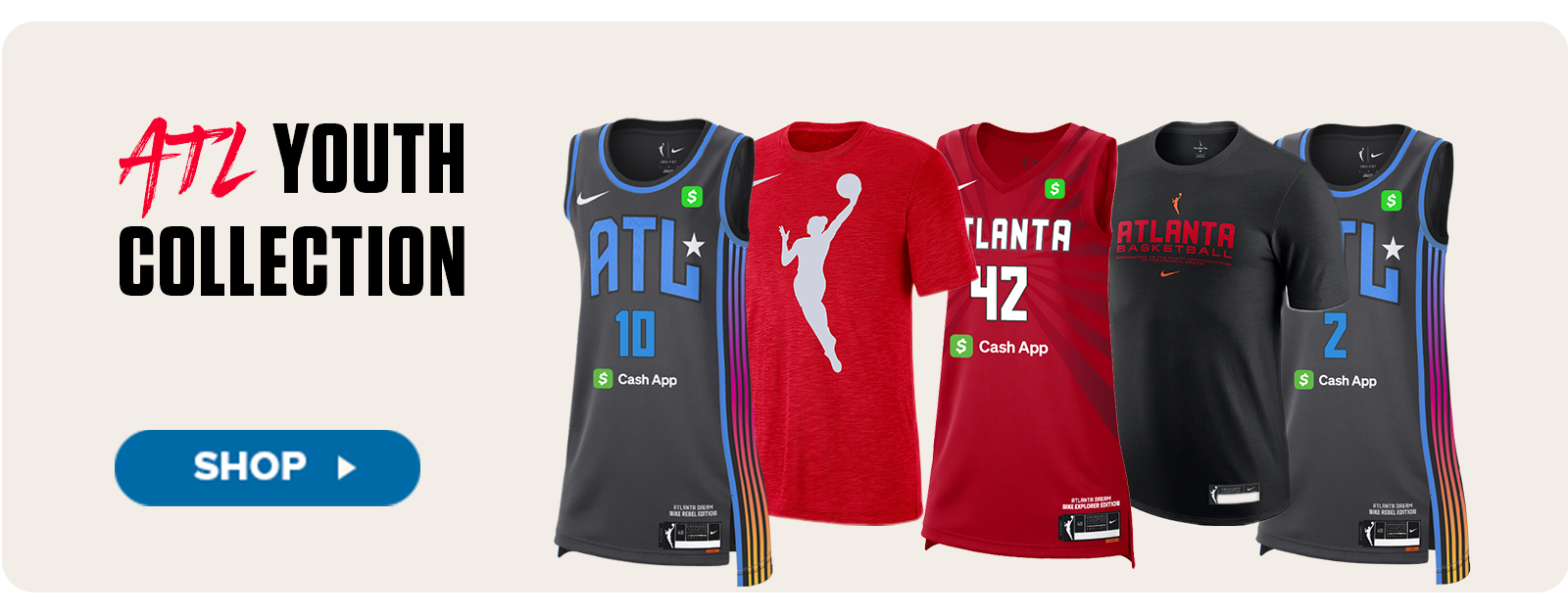 A lineup of five youth-sized Atlanta Dream apparel items is displayed under the headline “ATL Youth Collection.” The products include black and red basketball jerseys featuring player numbers, a red WNBA logo t-shirt, a red Atlanta Dream jersey with the number 42, and a black tee with “Atlanta Basketball” printed across the chest. Each piece includes the Nike and Cash App logos. A “Shop” button on the left invites viewers to explore the collection.