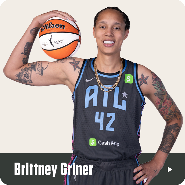 Brittney Griner poses confidently in her black Atlanta Dream jersey with the number 42 and Cash App sponsor logo. She rests a WNBA Wilson basketball on her raised left shoulder, showcasing her arm tattoos and gold chains. Her name appears in bold white text at the bottom of the image.







